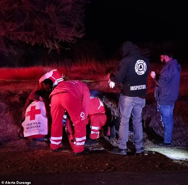 Paramedics tend to Chicago teenager Jason Peña, who was shot in the head during a roadside attack that killed his father, uncle and cousin Friday in Santiago de Papasquiaro, a city in the northern state of Durango.