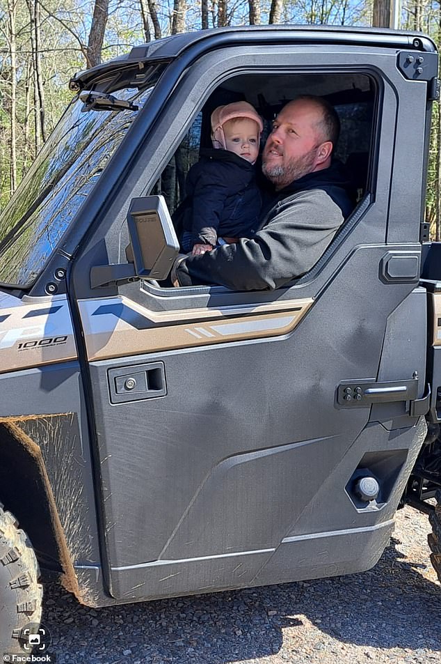 The toddler appeared to have fallen from the vehicle and was eventually run over by it, state troopers said. Pictured: Ellieana Mishoe and her father, Woody, sit in a UTV