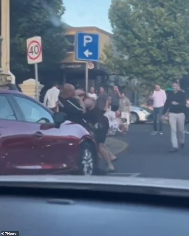 Shocked onlookers filmed the fight from inside their car as the men began throwing punches at each other.