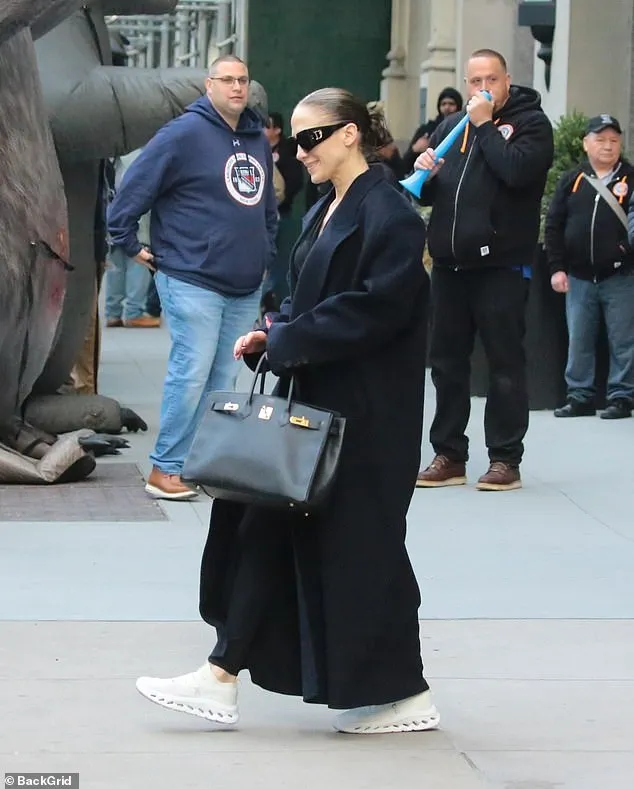 For her latest outing, she bare essentials in a black Hermès Birkin with gold accents and kept her long brunette hair slicked back in a low bun.